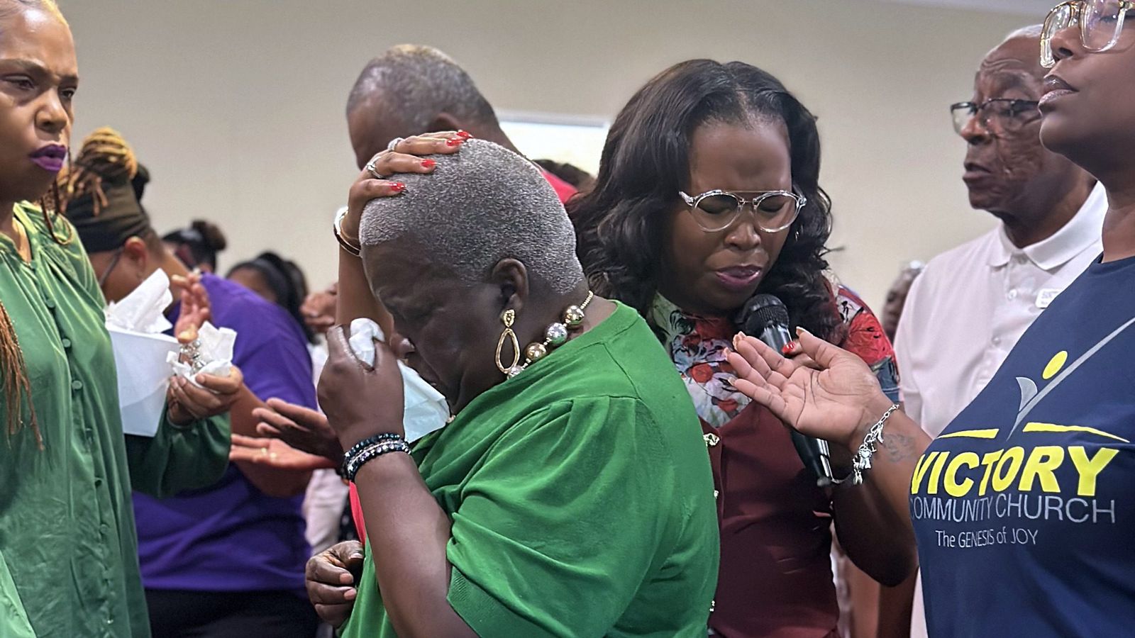 Members praying over one another